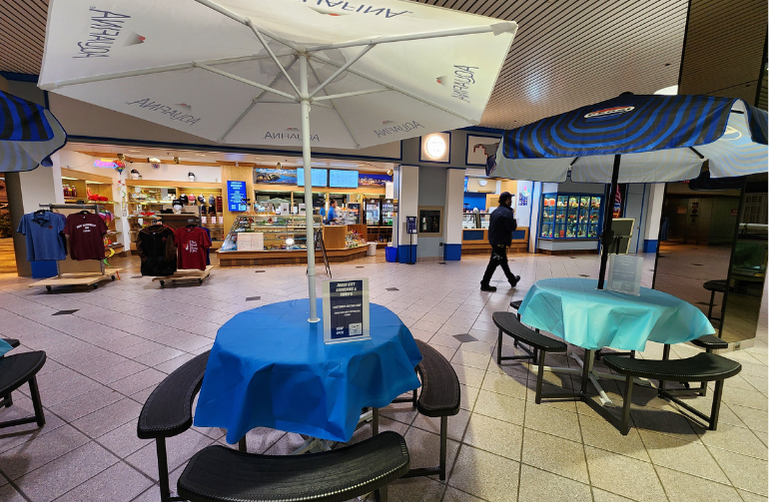 Inside Foggy City Sweets and Souvenirs, Uptown Saint John — cozy seating area with umbrellas and bright displays of local gifts and sweets.