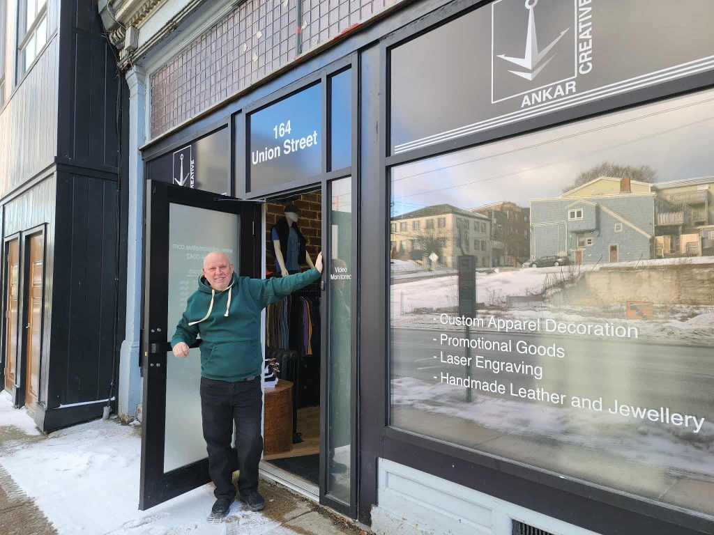 Exterior of Ankar Creative at 164 Union Street in Uptown Saint John, with Fernand standing in the open doorway.