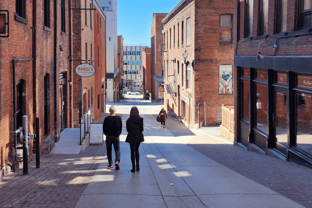 Couple walking along historic brick street in Uptown Saint John, New Brunswick